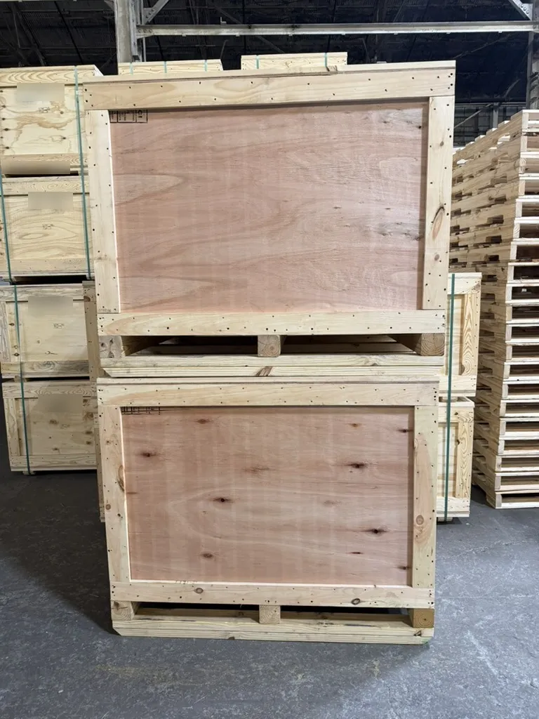 Stacked plywood export crates on skid bases at Victor Wood Products Baltimore
